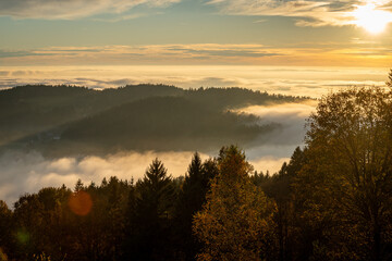 Beautiful landscape in autumn with ground fog in the valley at sunset in Bavarian Forest