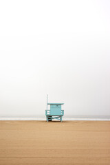 blue cabin on the beach, in the middle of the beach of a cloudy sea, landscape of the state of California