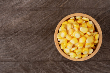 corn in a bowl on a wooden table