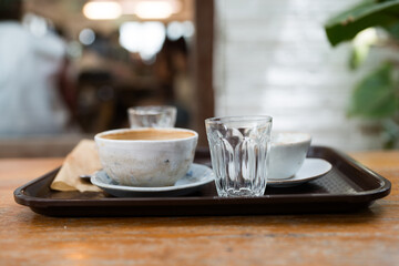 Empty coffee cup after drink on a wooden table. Concept for ending a meeting or something else. Cafe culture.