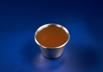 A portion of fried chicken with sweet and sour sauce close-up