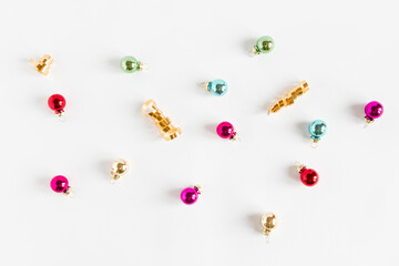 Christmas composition. Christmas colorful small balls on the white background. Flat lay top view copy space.