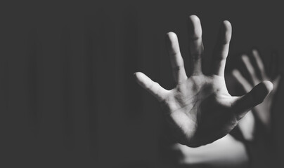 Close up of  woman showing stop gesture with hand blurred background. Stop violence against women. Intimidation and abuse of women.  Physical and psychological harassment.