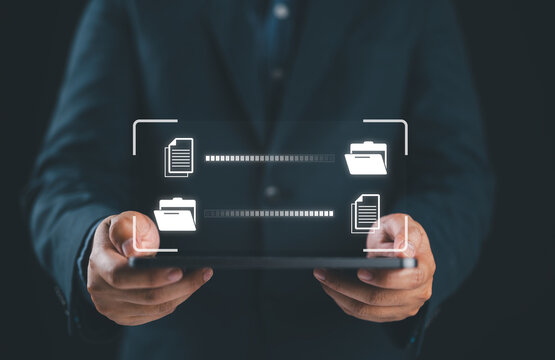 Data Sync concept, Transfer file of data between folder, Backup data, Exchange of file on folder, Send document in internet, DMS. Virtual document loading to another folder and hand holding tablet.