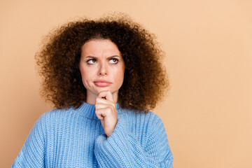 Photo portrait of lovely young lady look skeptical empty space dressed stylish blue knitwear...