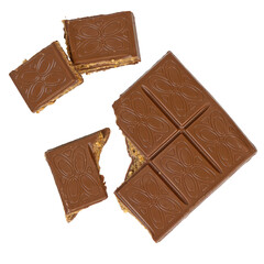 Milk chocolate pieces filled with cookie dough caramel butter nuts filling stacked isolated on white background