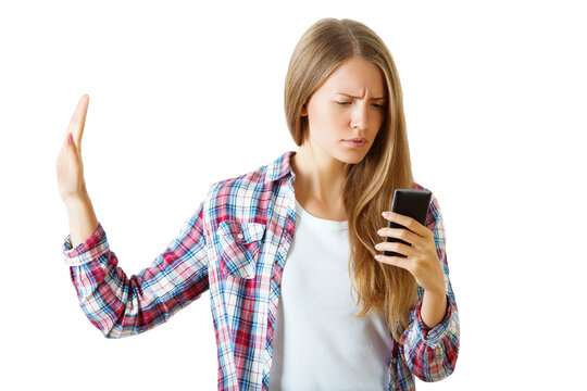 Woman in plaid shirt holding up a hand in a stop gesture while looking at a phone, isolated on white background, concept of disapproval