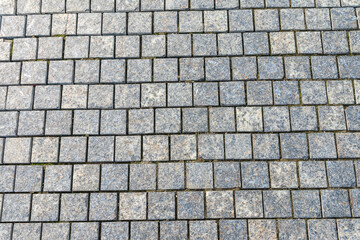Obraz premium Stone block pavement in the rays of the setting sun. Texture