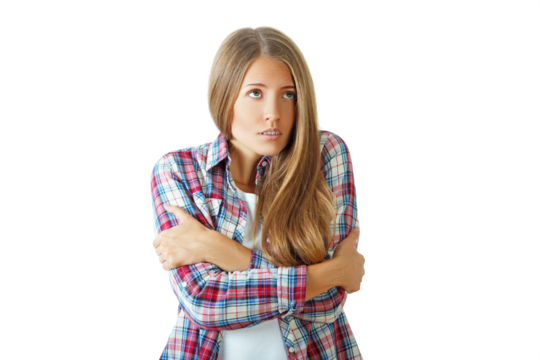 Woman in a plaid shirt hugging herself, looking worried, isolated on a white background. Concept of anxiety or cold