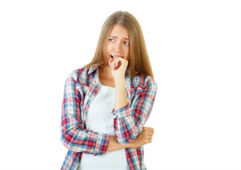Young woman biting nails, wearing plaid shirt, isolated on white background, expressing anxiety. Concept of worry and stress