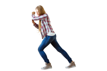 Woman in jeans and plaid shirt pushing an invisible object, isolated on white background. Concept of exertion and effort