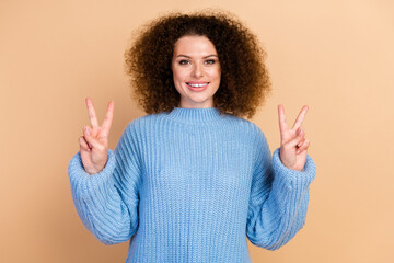 Portrait photo of young charming beautiful curly haired lady in blue fall season sweater...
