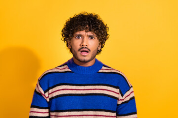 Photo portrait of handsome young guy horrified amazed face dressed stylish blue striped garment isolated on yellow color background