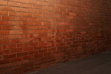Red color brick wall for brick background design. with flash light, in the city