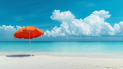 Orange Beach Umbrella on White Sand Beach with Blue Sky and Turquoise Water