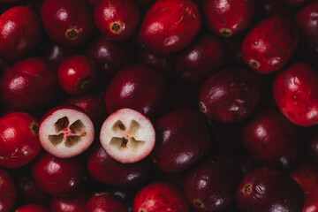 Cranberry berries are large, and one berry is cut in half