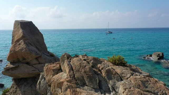 Aerial view of sea and rocky beach in Marinella Di Zambrone on a sunny summer day in Calabria, Italy