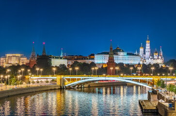 Fototapeta premium Illuminated Moscow Kremlin and Bolshoy Kamenny Bridge at summer night. View from the Patriarshy pedestrian Bridge