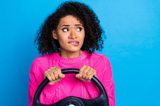 Photo of guilty scared lady dressed knitted pullover driving auto looking empty space isolated blue color background