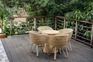 Table and rattan chairs at the balcony 