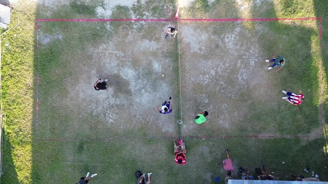 Aerial view of group of young men are playing takraw in the afternoon