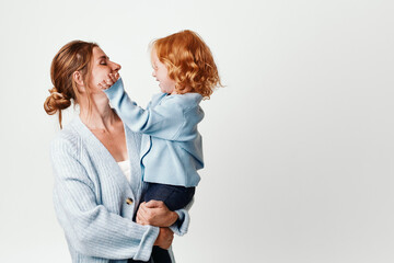 Mother and daughter embracing in front of white background love, family, connection, happiness, joyful, parenting, relationship, bonding, togetherness