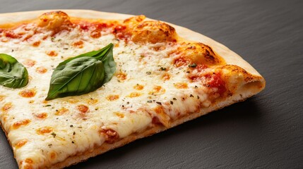 Delicious slice of cheese pizza topped with fresh basil on a wooden background.