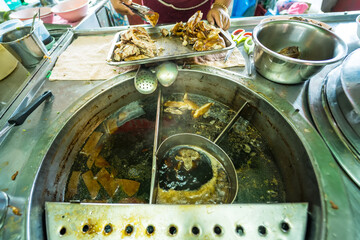 Street Vendor's Chicken Noodle Soup Simmering in a Large Pot, Traditional Thai Flavors in Every Scoop