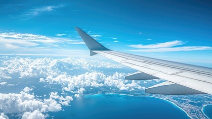Obraz premium Plane Wing With Blue Sky Mainland And Clouds In The Background