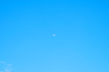 Beautiful blue clouds and a distant moon. For the background.