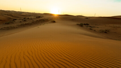 Golden hour in deep desert with golden untouched sand with clear sky during holiday desert safari in winter