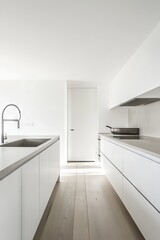Fototapeta premium A minimalist modern kitchen featuring white cabinets, stainless steel fixtures, and ample natural light, creating a clean and bright atmosphere.