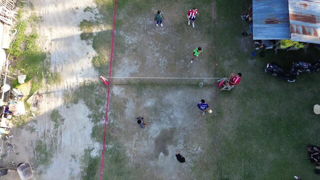 Aerial view of group of young men are playing takraw in the afternoon