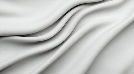 Obraz premium Soft white fabric drapes elegantly, showcasing smooth texture and gentle curves, perfect for showcasing luxury and comfort.