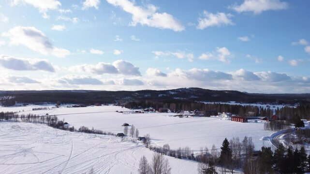 Ascending through the treetops revealing a beautiful northern winter landscape in Pite&aring;, Sweden