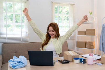 A fashionable woman wearing beautiful attire stands beside a mannequin adorned with trendy clothes...