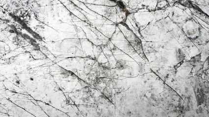 A close-up of a textured marble surface with natural black and gray veining, giving an abstract appearance.

