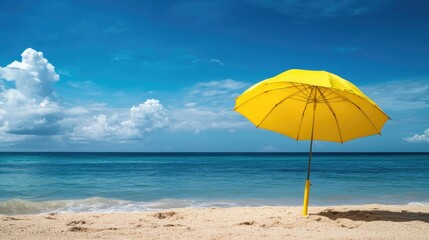 Yellow umbrella on the beach by the ocean evoking a sense of wanderlust and relaxation ideal for travel themed imagery
