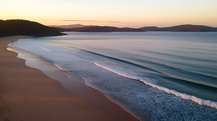 Fototapeta premium Serene beach at dawn with gentle waves