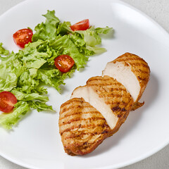Grilled Chicken Breast with Fresh Salad on Minimalist White Plate