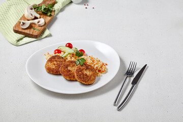 Delicious Turkey Cutlets with Rice and Vegetables on a Stylish White Plate