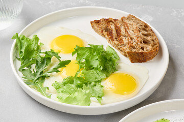 Minimalist Breakfast Bright Sunny-Side Up Eggs with Toast