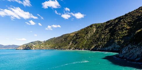 Sea, rocks and clouds on blue sky