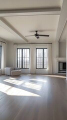 Obraz premium A large room with a white ceiling and white walls. A black fan is mounted on the ceiling. The room is empty and has a clean, modern look