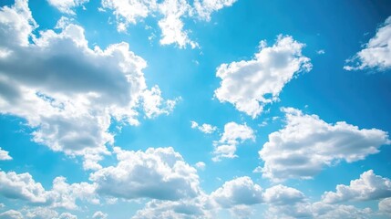Vast blue sky adorned with soft white clouds on a bright sunny day creating a panoramic backdrop