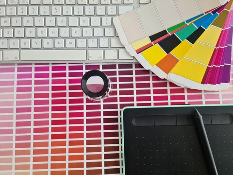 Creative workspace featuring color swatches, a drawing tablet