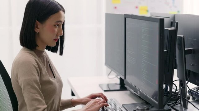 Focused Female Programmer Coding in Office.