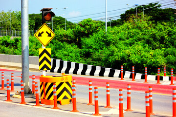 traffic cones,  bumper, traffic sign, orange flashing light  group of traffic sign on road