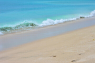 Blurred tropical beach with blue water and clean sand