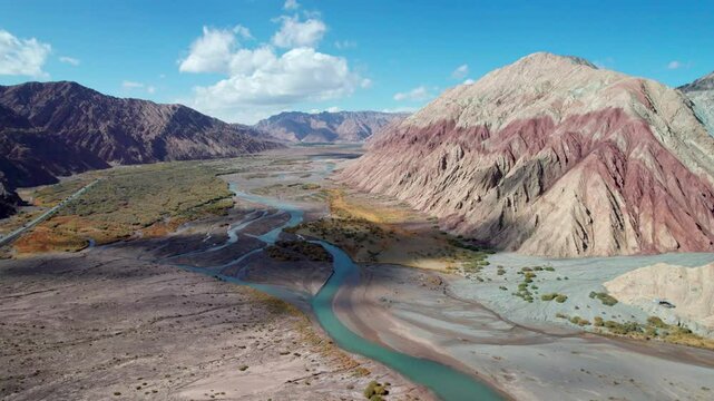Drone view of Yadan landform near Kashgar in southern Xinjiang, China. High angle view of colorful mountains in sunny autumn day, 4k fast motion time lapse landscape footage b roll establishing shot.